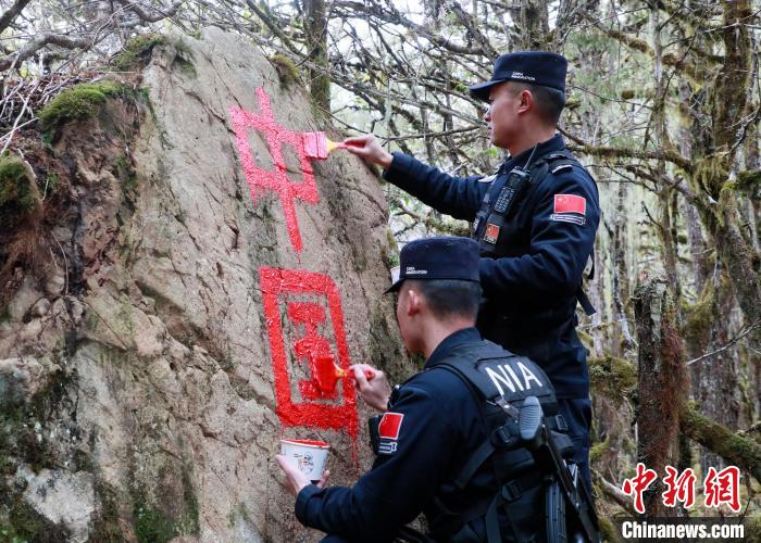 山南邊境管理支隊玉麥邊境派出所民警邊境巡邏途中在石頭上用油漆涂寫“中國”二字 。　鄭琦山 攝